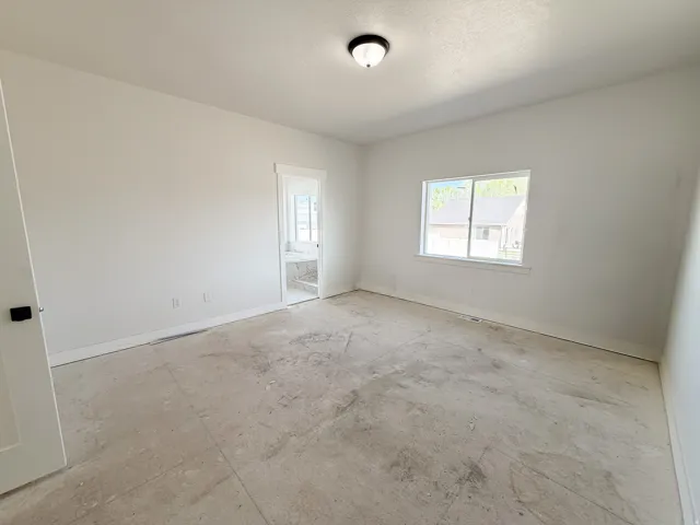 Spare room featuring baseboards
