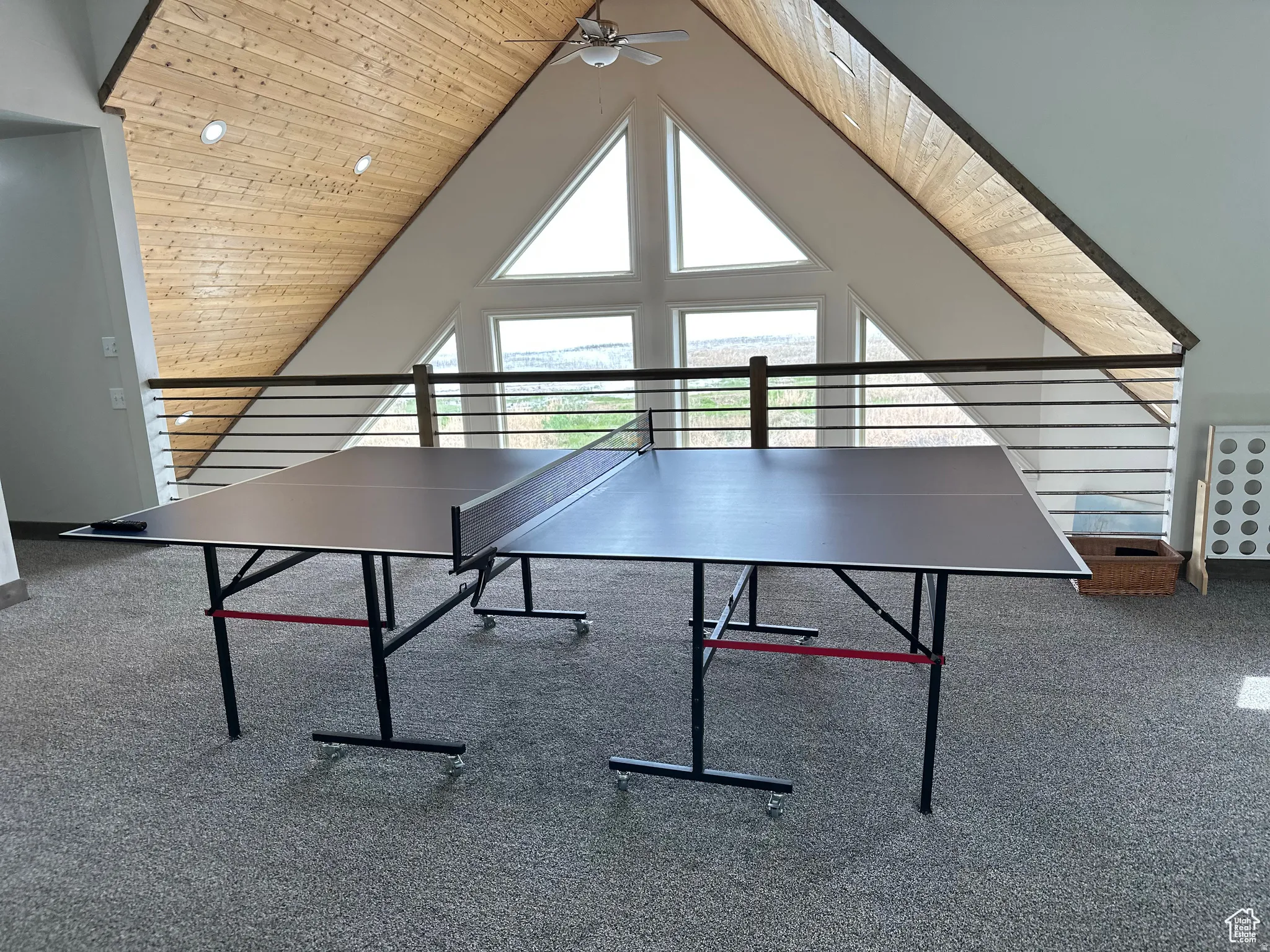 Recreation room featuring ceiling fan and a high wooden ceiling