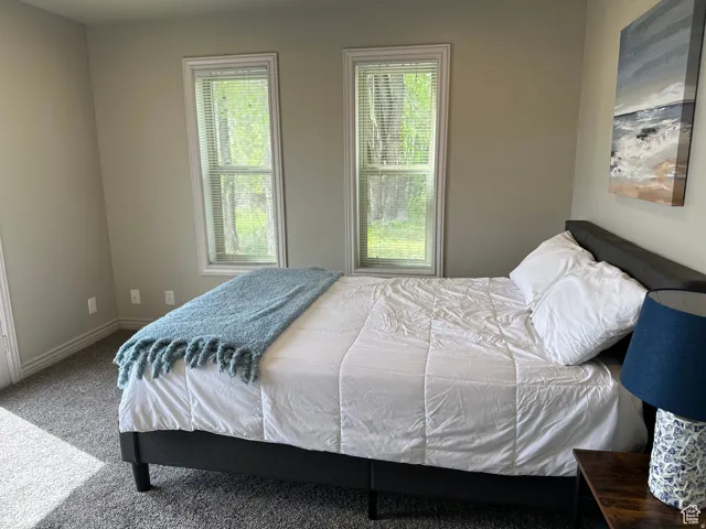 Bedroom featuring carpet flooring and baseboards