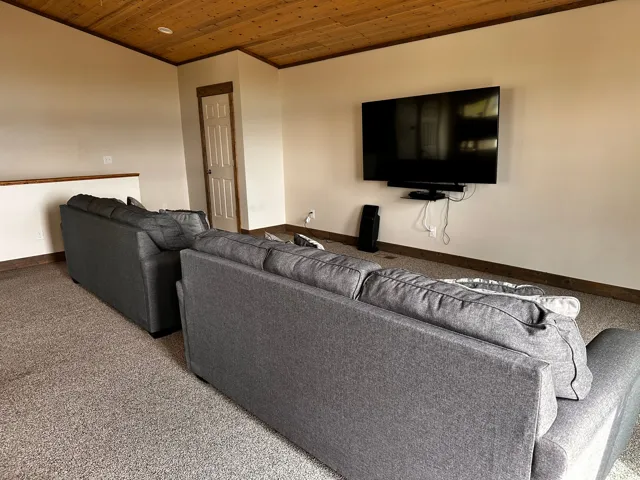 Living area with wooden ceiling and crown molding
