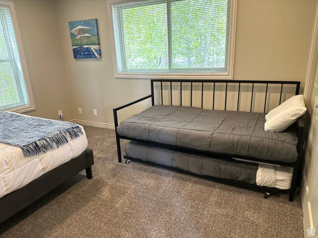 Carpeted bedroom featuring baseboards
