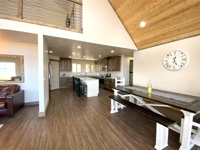 Dining area with recessed lighting, dark wood-style floors, and a vaulted wooden ceiling