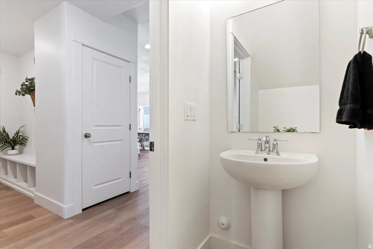 Bathroom with light wood-style floors and baseboards