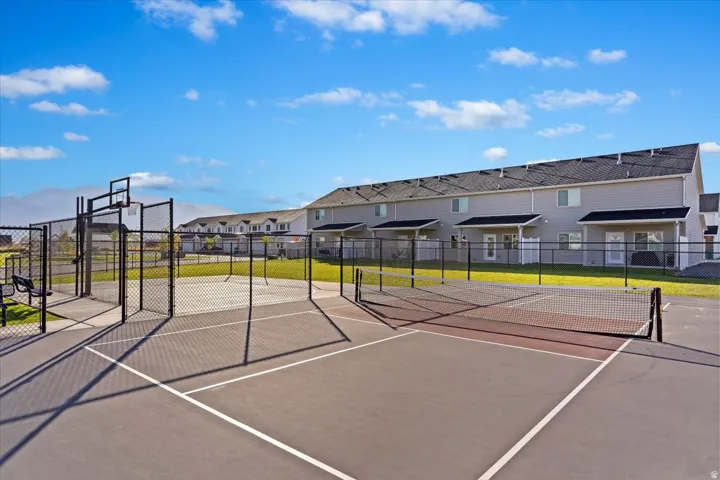 View of tennis court featuring a residential view