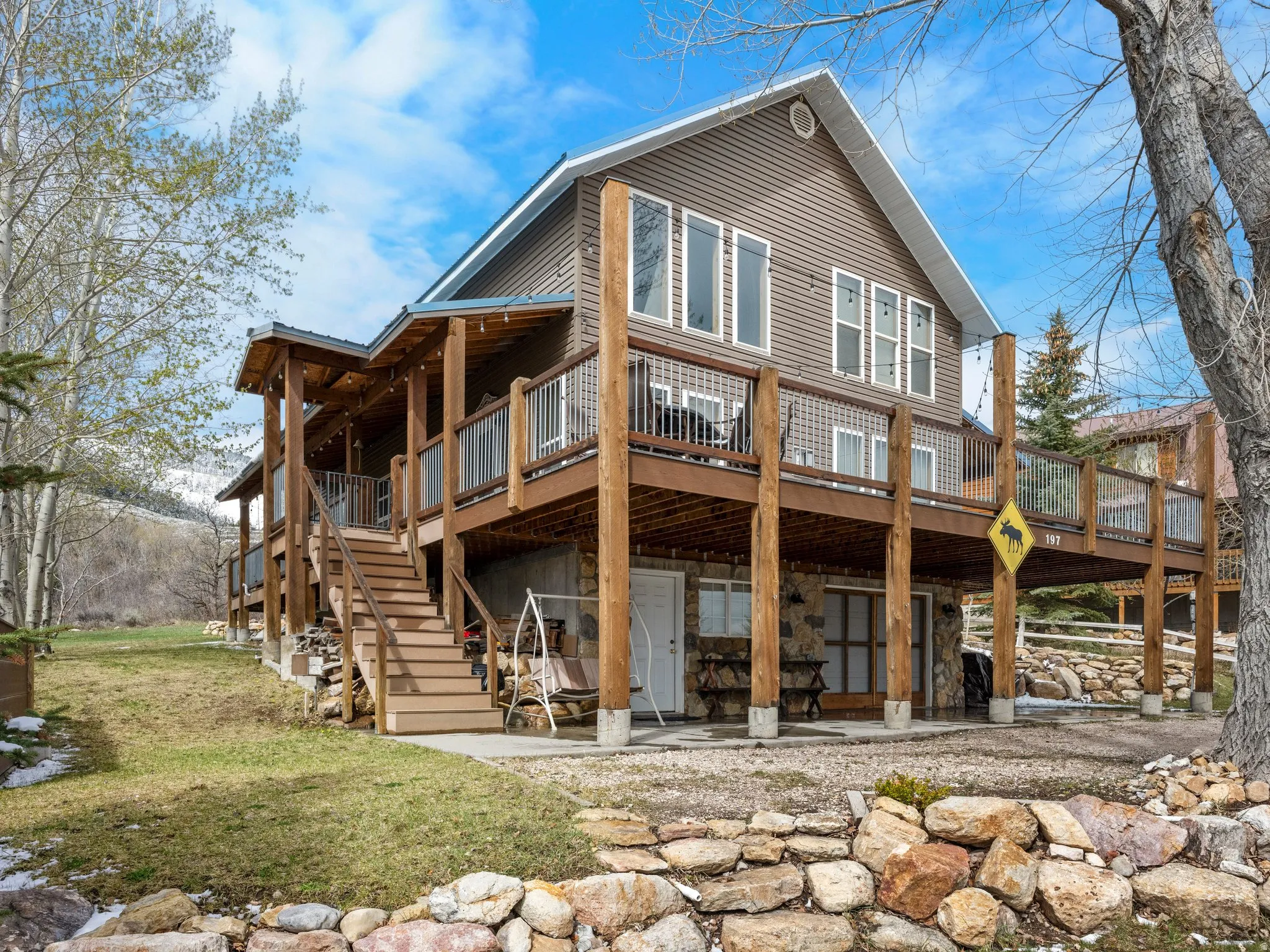 Back of house featuring a deck and a patio area
