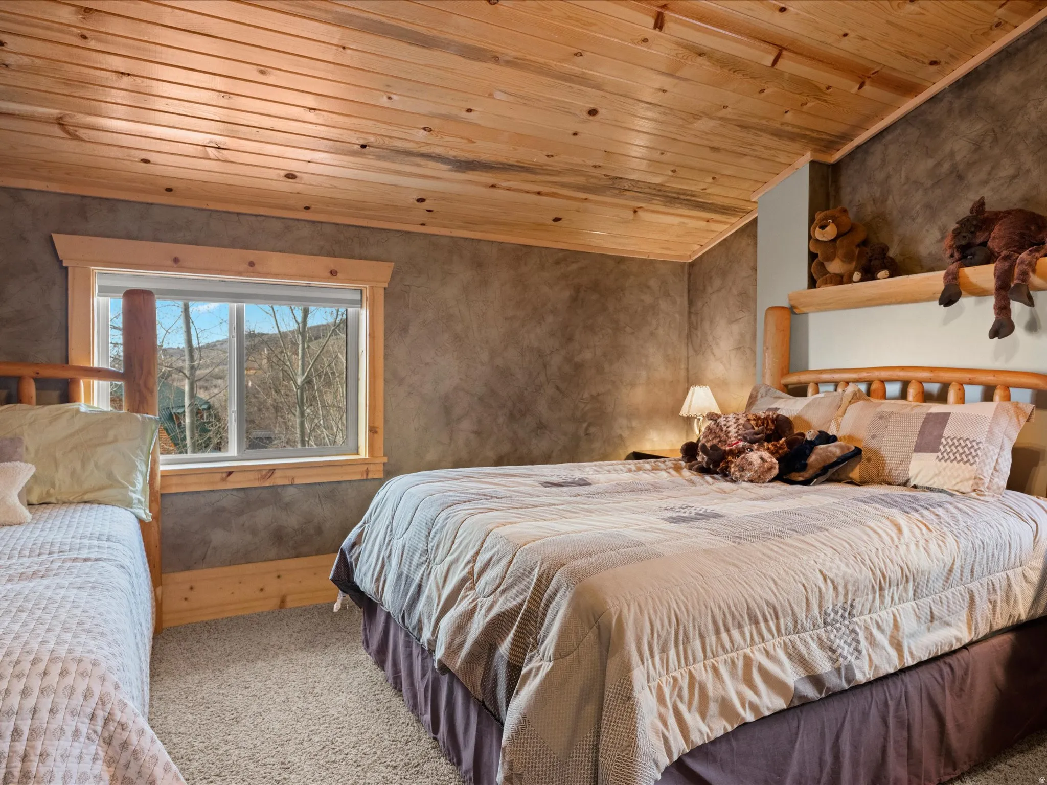 Bedroom with carpet floors and wooden ceiling