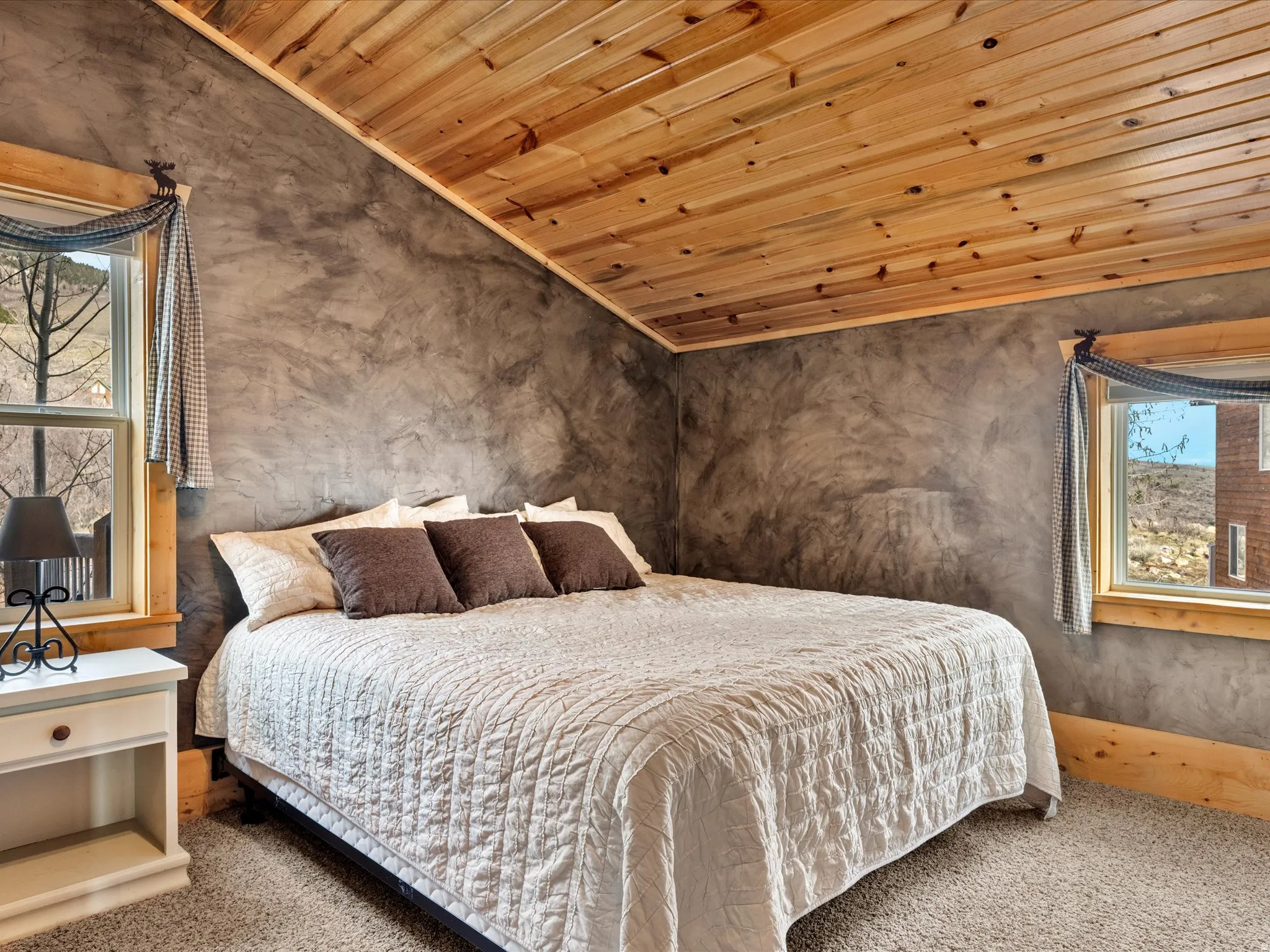 Bedroom with a vaulted wooden ceiling, crown molding, and carpet floors