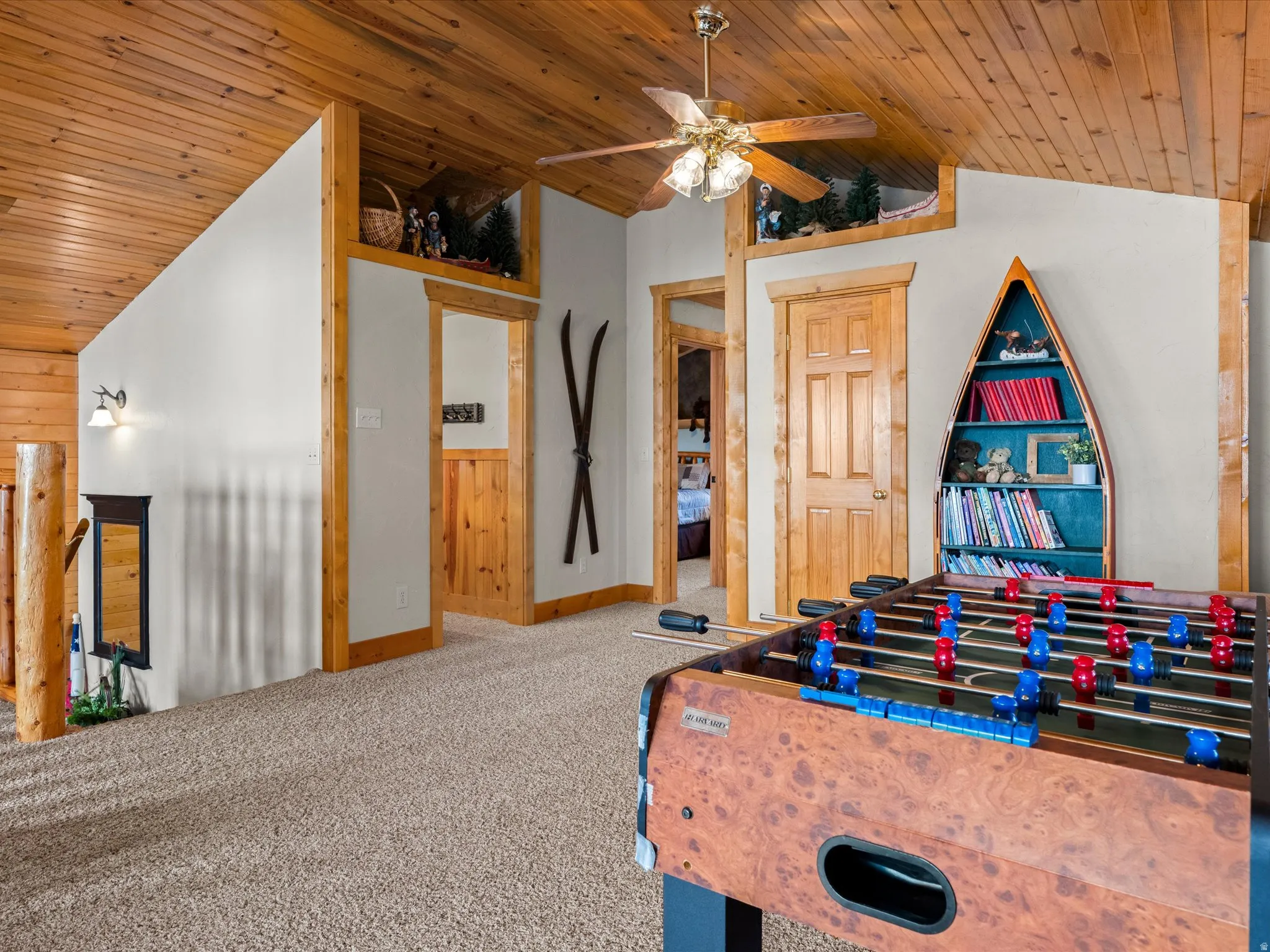 Recreation room featuring a vaulted wooden ceiling, ceiling fan, and carpet