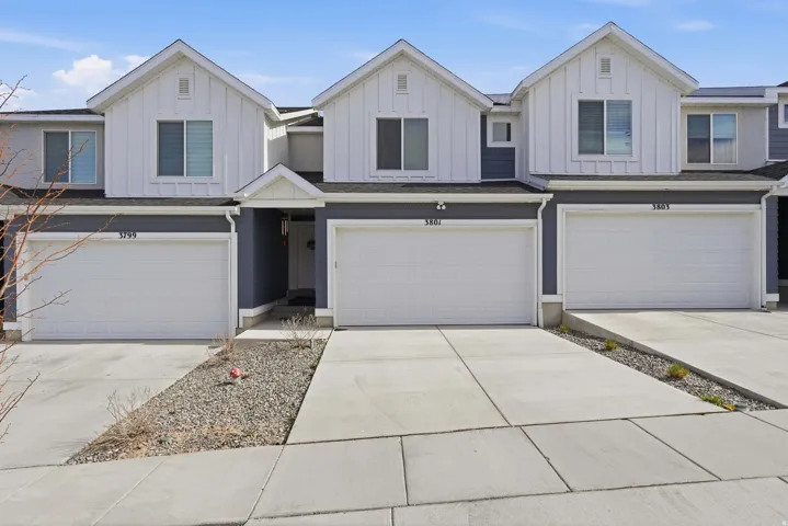 View of front of property featuring a garage, board and batten siding, and concrete driveway