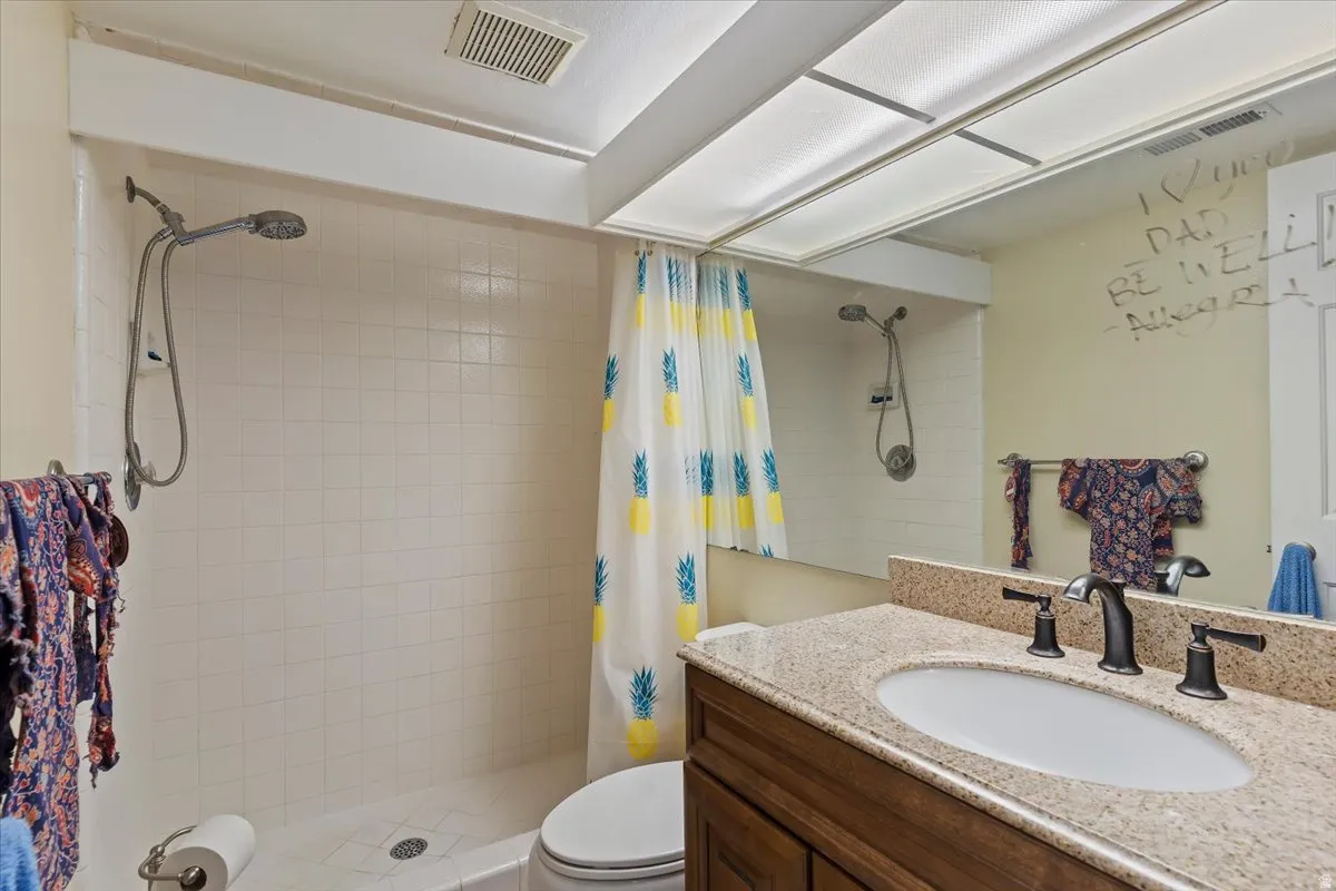 Bathroom featuring vanity and a shower stall