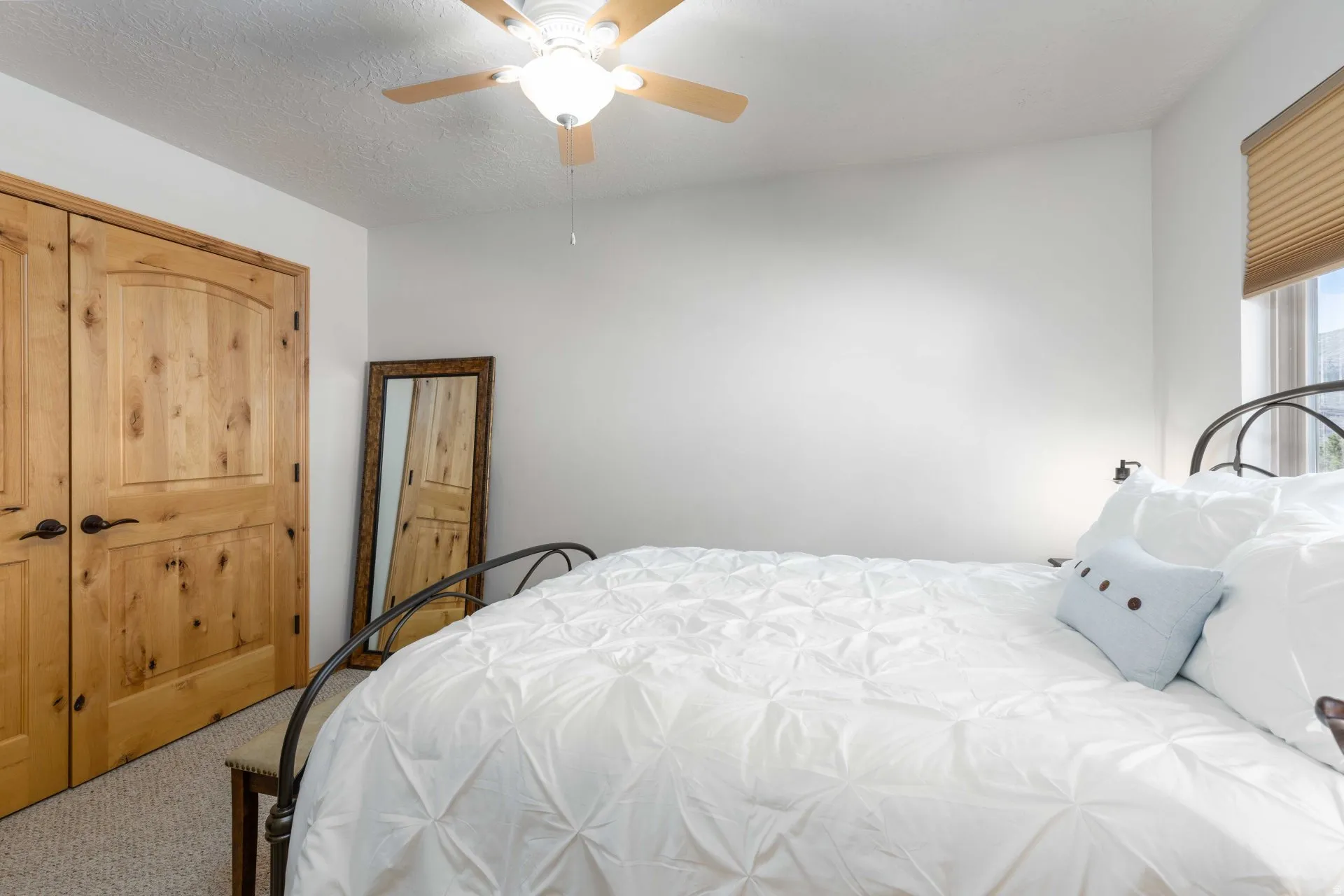 Bedroom with carpet, ceiling fan, and a textured ceiling