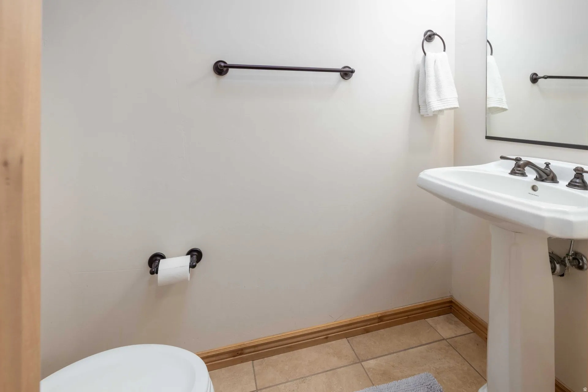 Bathroom with light tile patterned flooring and toilet