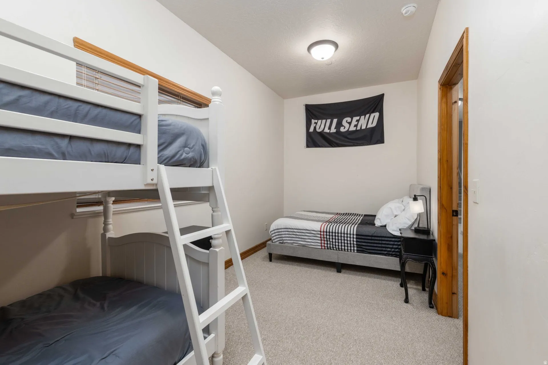 Bedroom featuring light colored carpet and baseboards