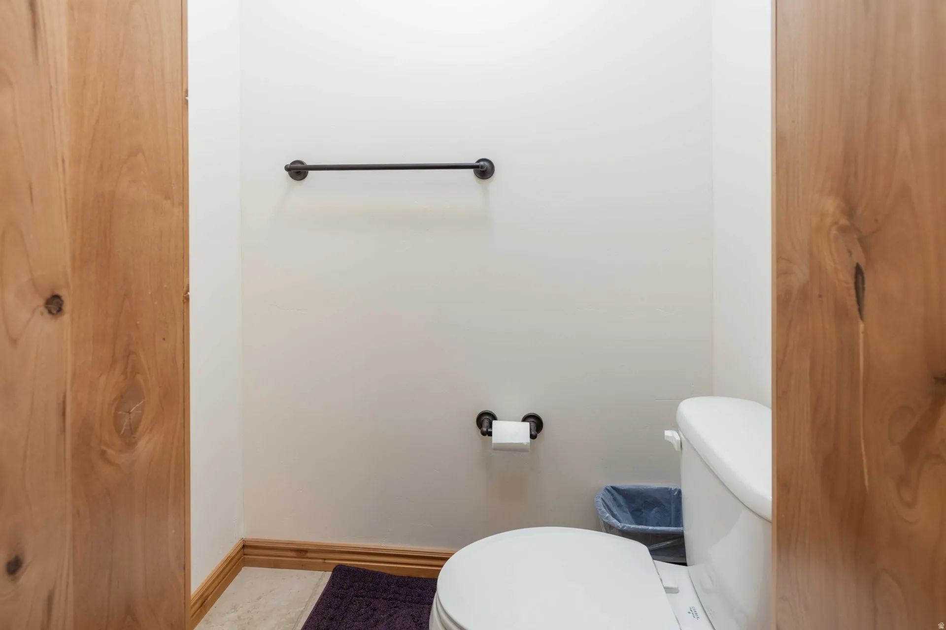 Bathroom with toilet and baseboards