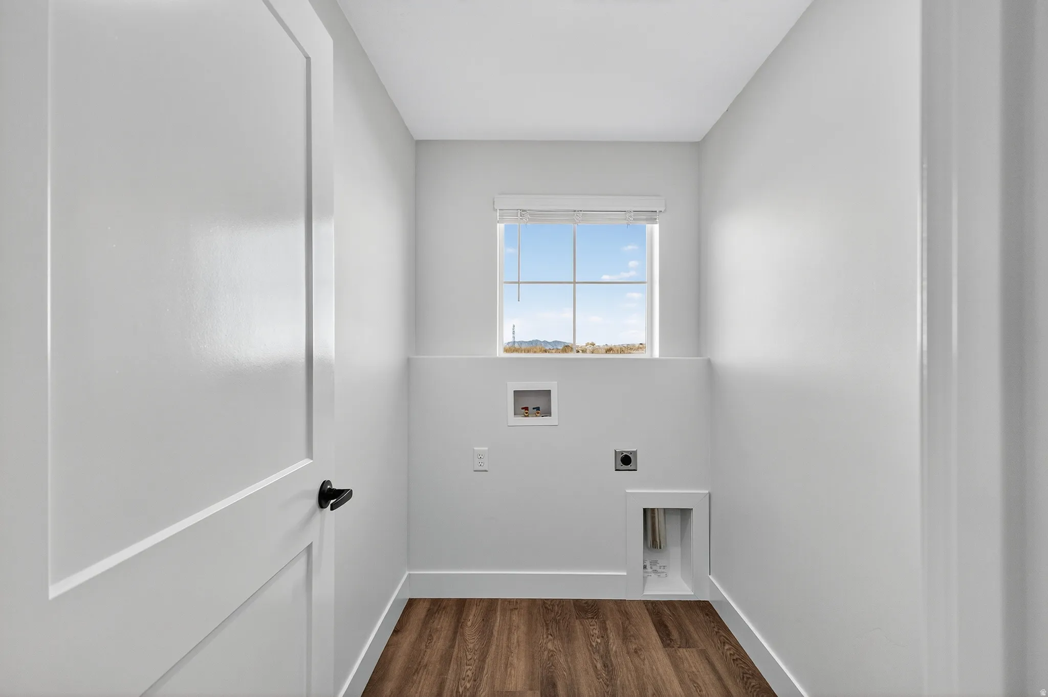 Laundry area with washer hookup, dark wood-type flooring, and hookup for an electric dryer