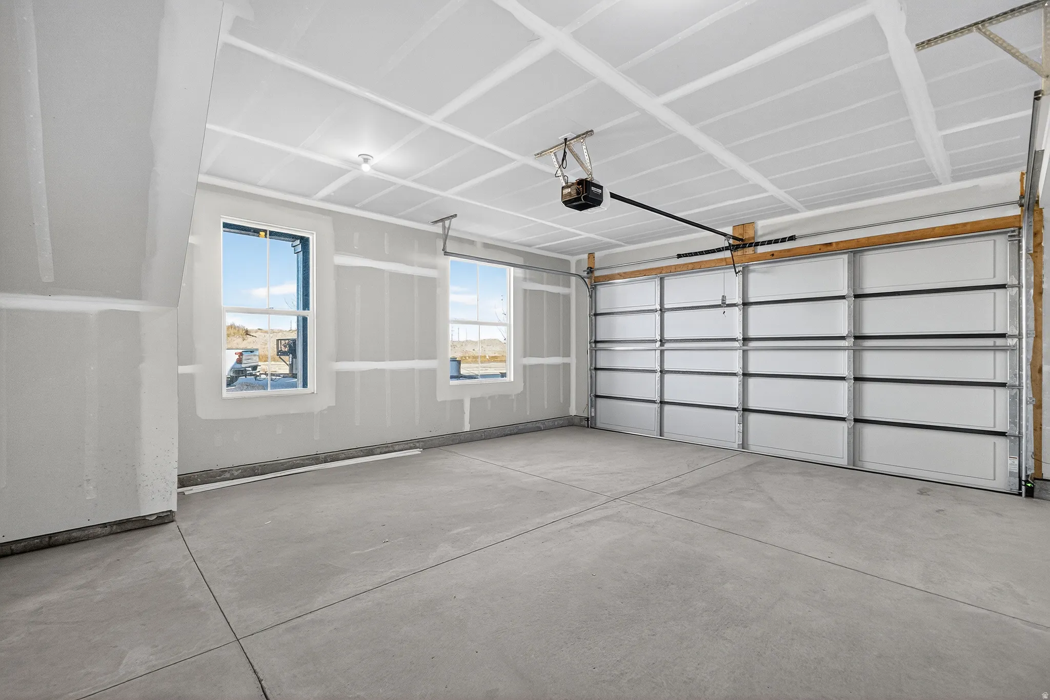 Garage featuring a garage door opener