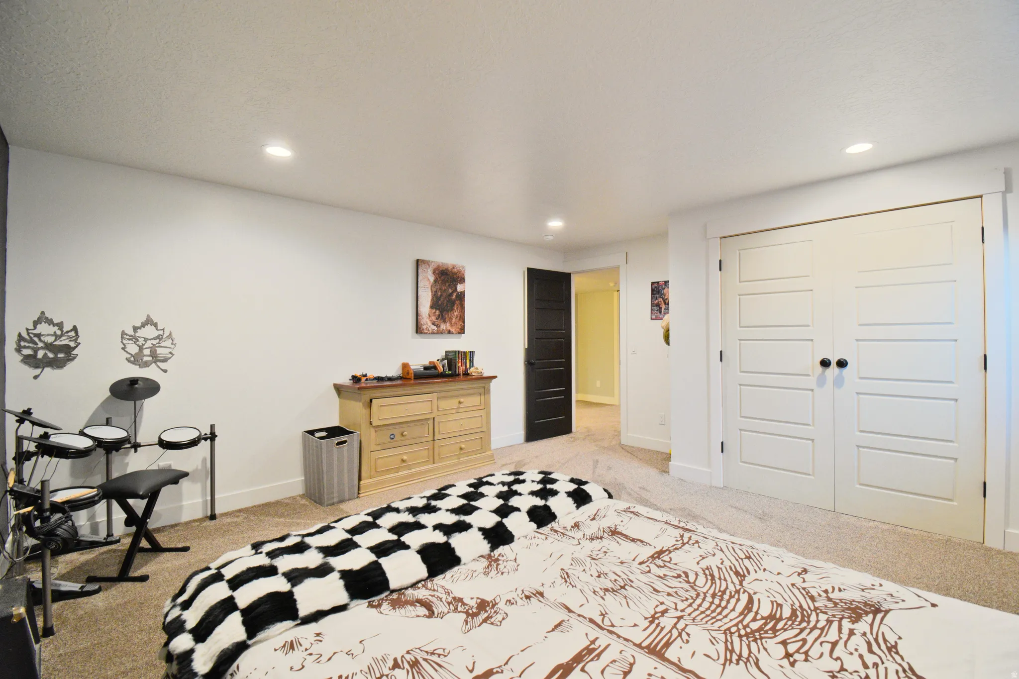 Bedroom featuring a closet, light colored carpet, and recessed lighting