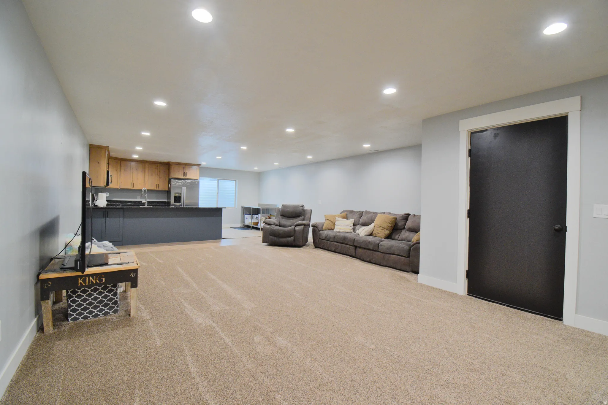 Living room with light colored carpet and recessed lighting
