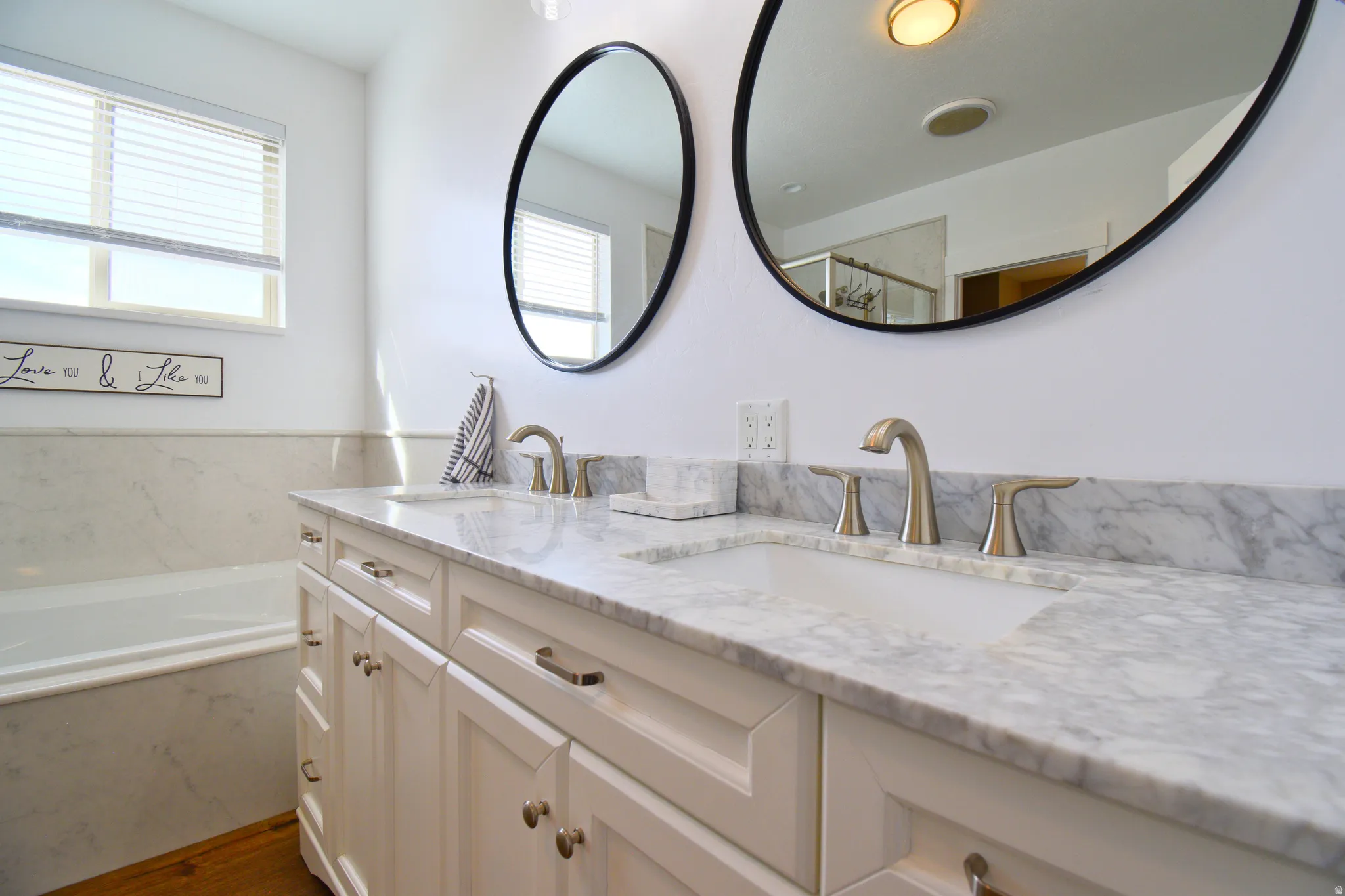 Bathroom with double vanity and a garden tub