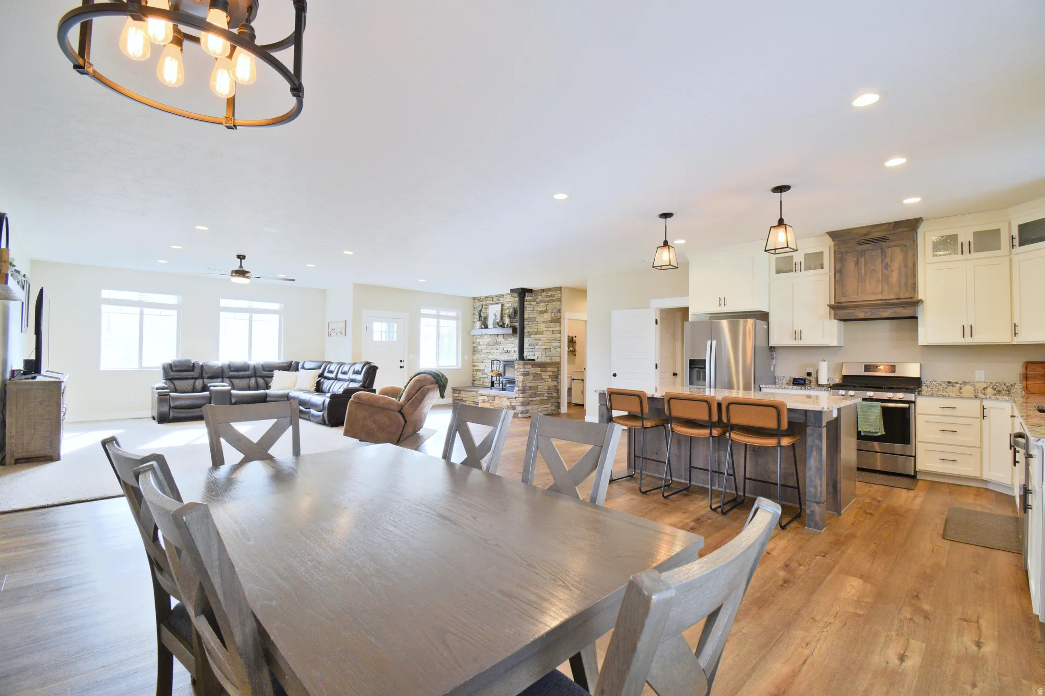 Dining space with light wood finished floors, a chandelier, and healthy amount of natural light