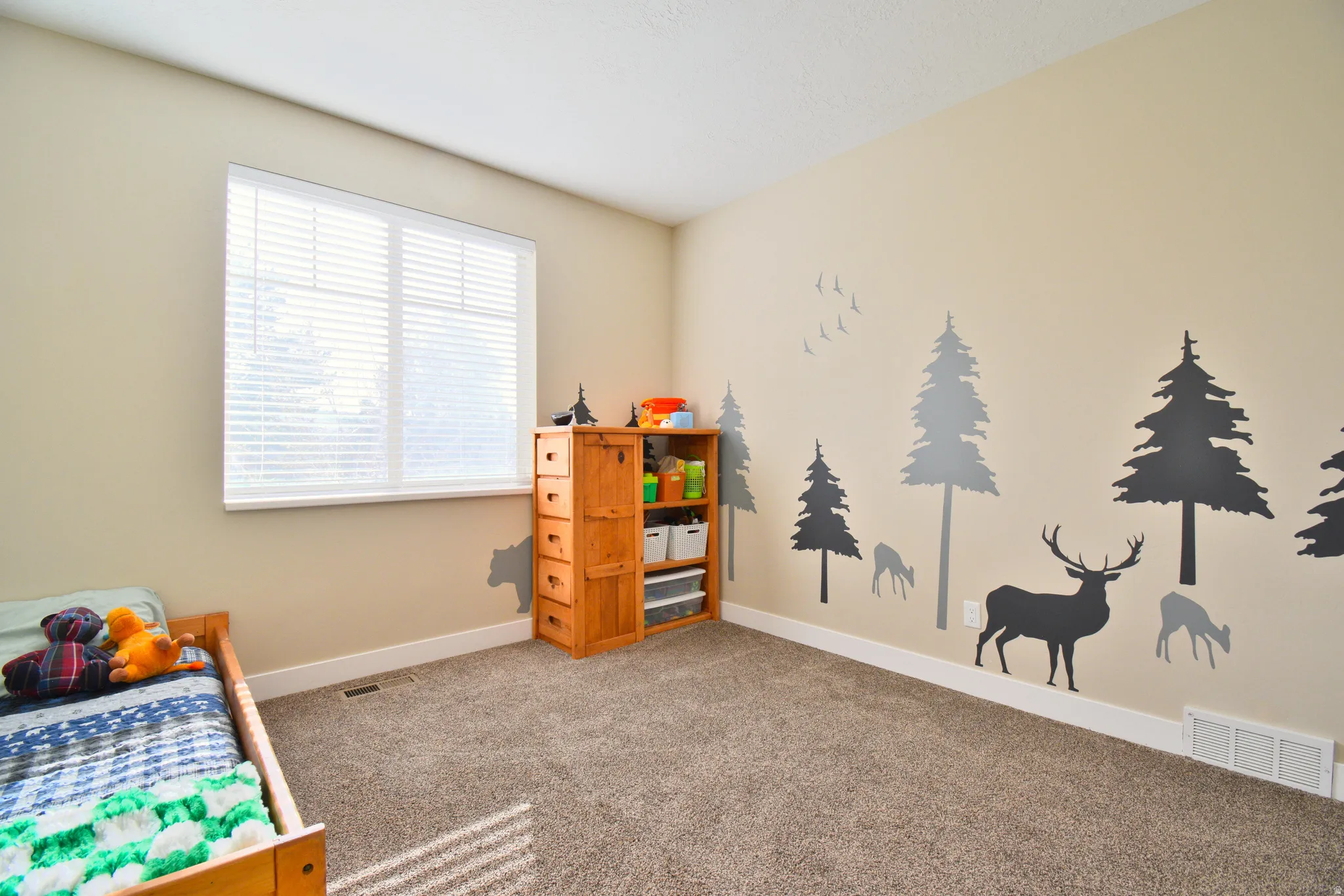 Bedroom featuring light colored carpet and baseboards