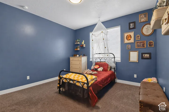 Room featuring blue painted walls and brown carpet flooring