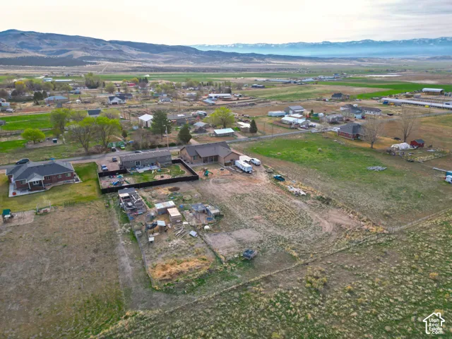 Aerial view of property's location featuring a mountainous background