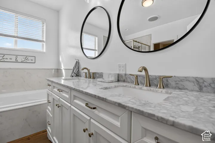Dual vanity with stone countertop, undermount sinks, and brushed nickel fixtures