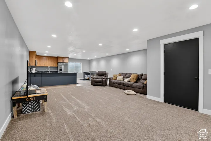 Open-concept living space featuring recessed lighting and light gray walls