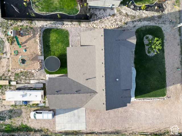 Expansive lot featuring a large residential structure, concrete driveway, and a substantial grassy area
