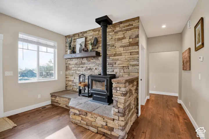 Stone accent wall featuring a black wood-burning stove
