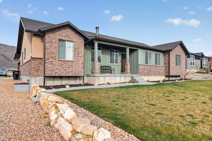 Ranch-style exterior featuring brick accents and vertical siding