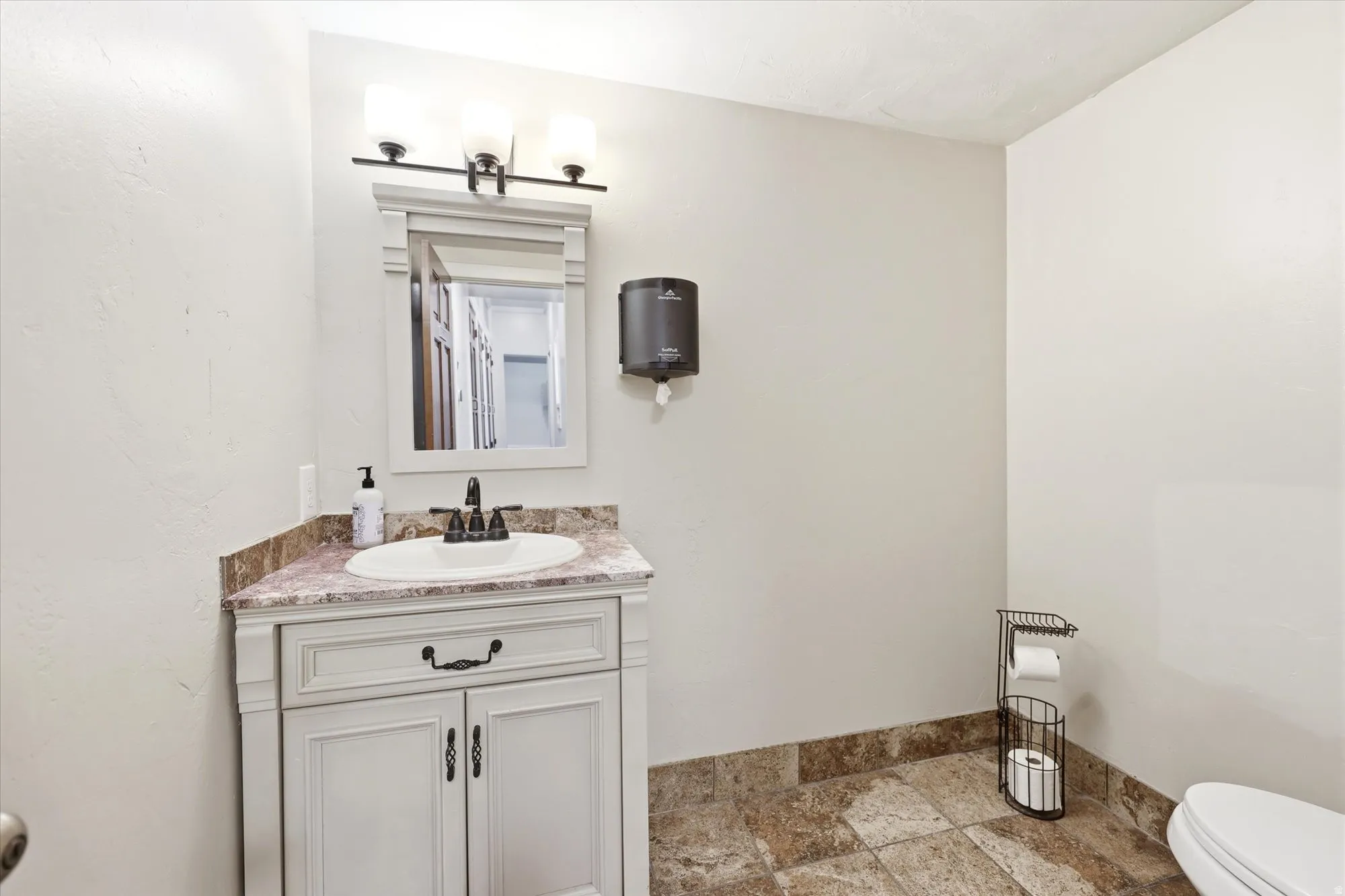 Bathroom vanity with a composite countertop and white porcelain sink