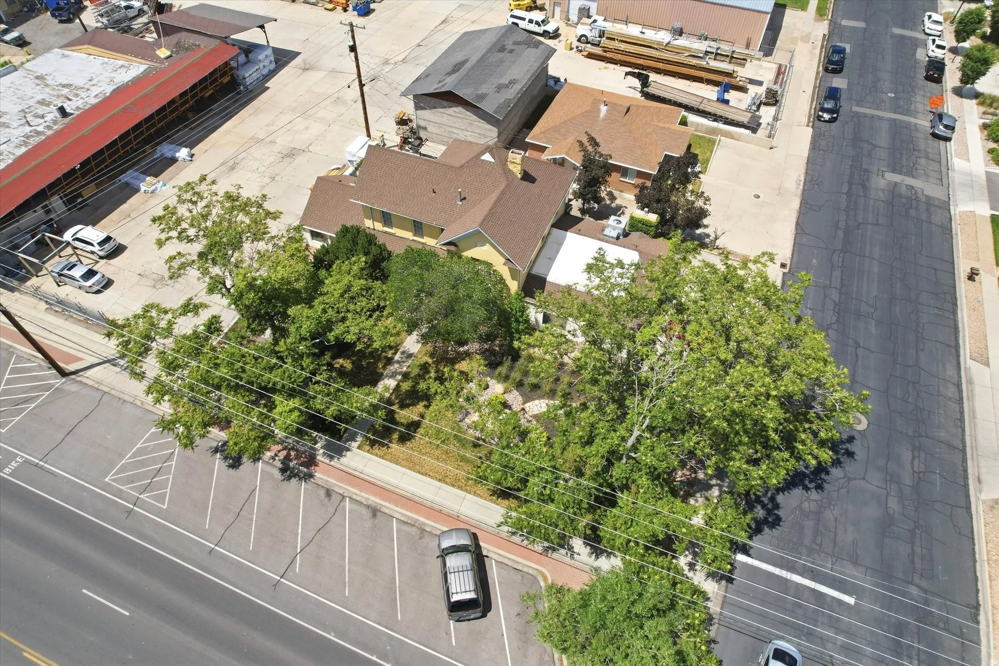 Single-story residence featuring a traditional roofline and mature trees providing natural shade