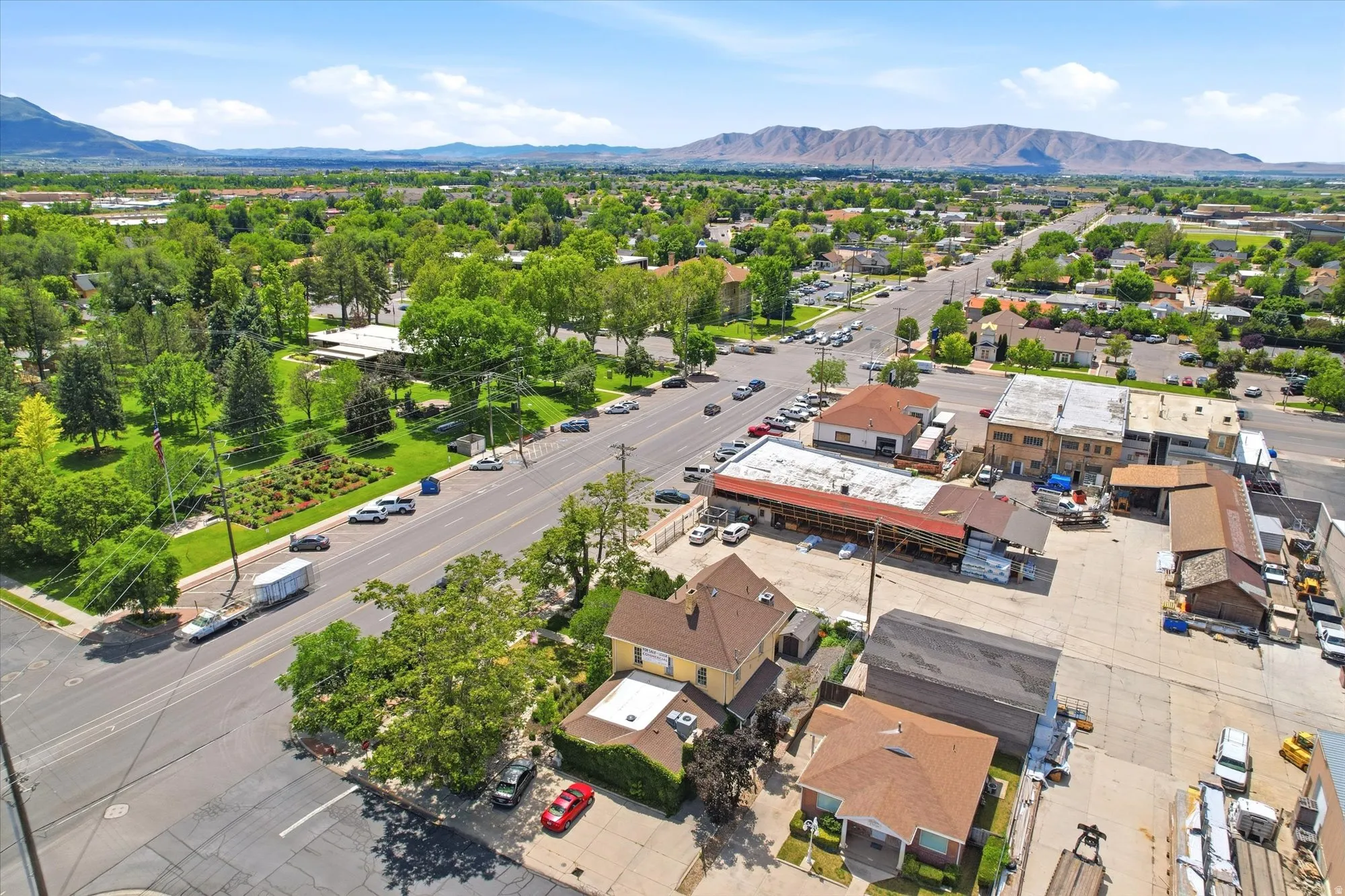 Aerial perspective showcasing a commercial property with multiple buildings and expansive paved parking areas