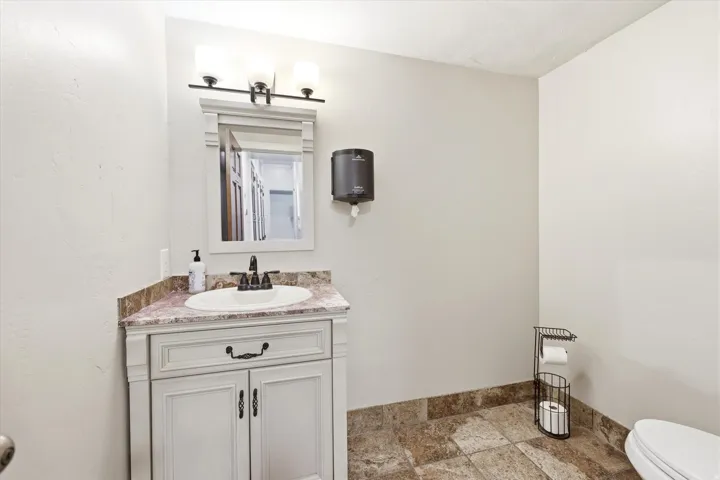 Bathroom vanity with a composite countertop and white porcelain sink