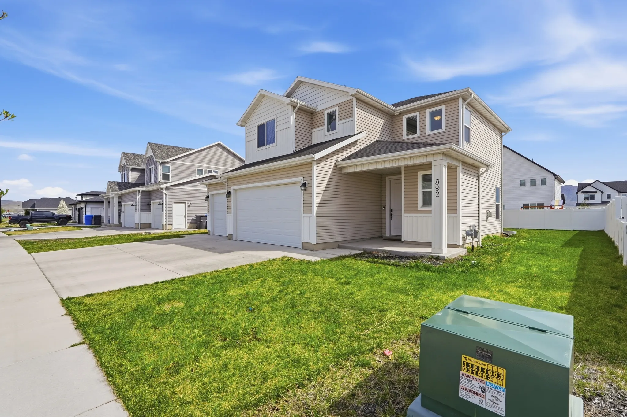 Traditional-style home with a residential view, driveway, a garage, and covered porch