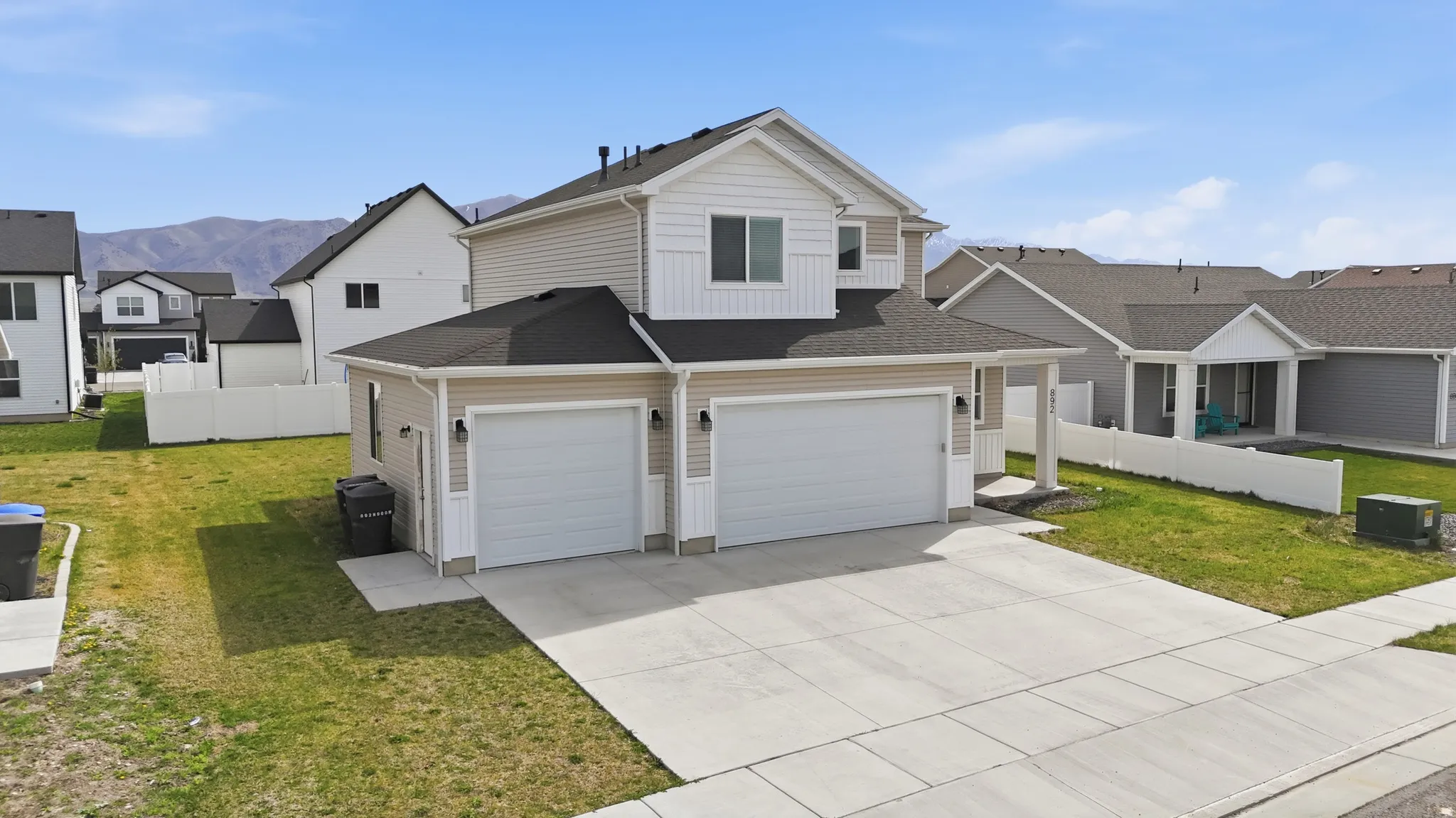 Traditional-style home with a residential view, driveway, a garage, board and batten siding, and roof with shingles