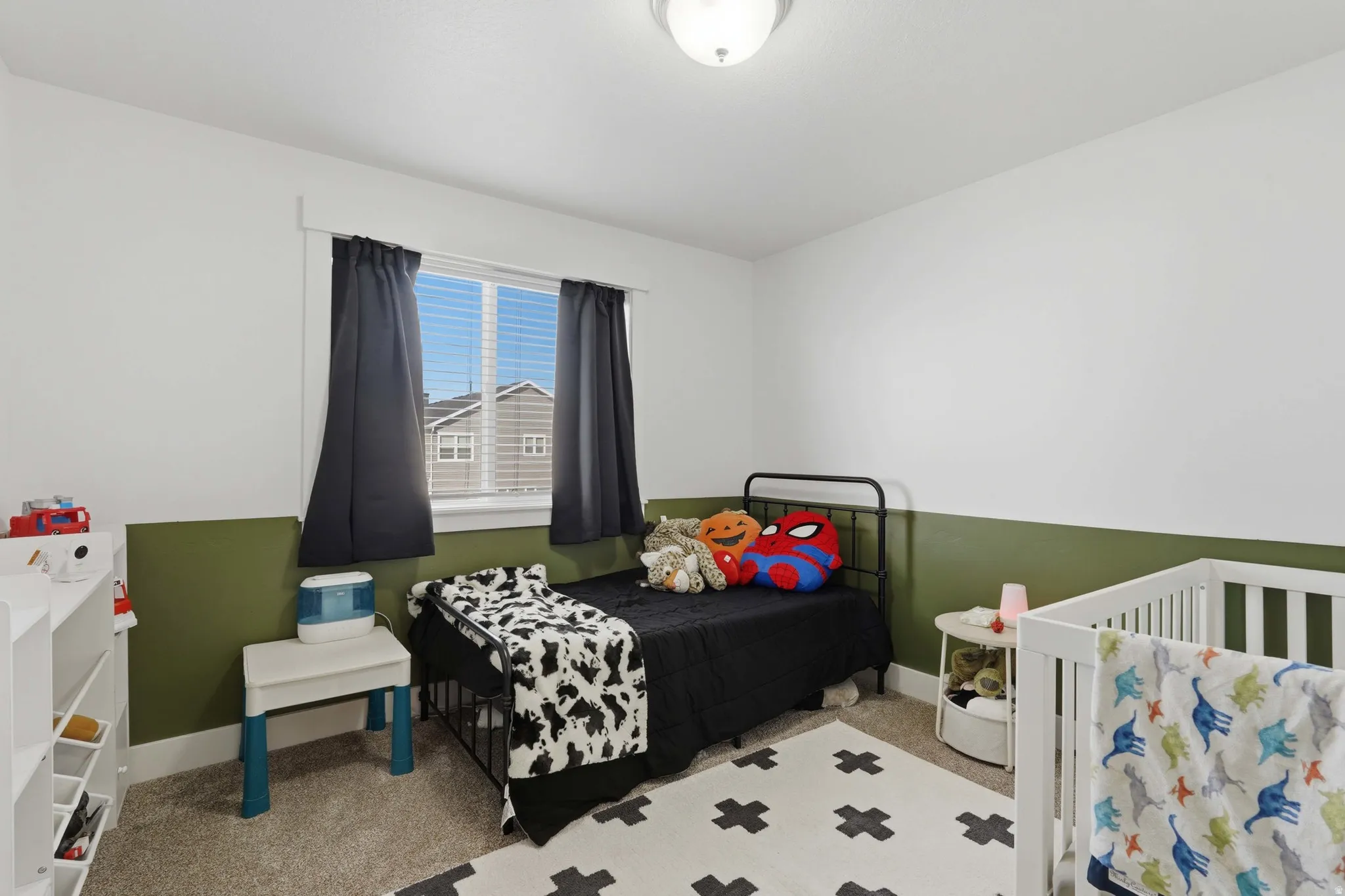 Bedroom featuring light colored carpet and baseboards
