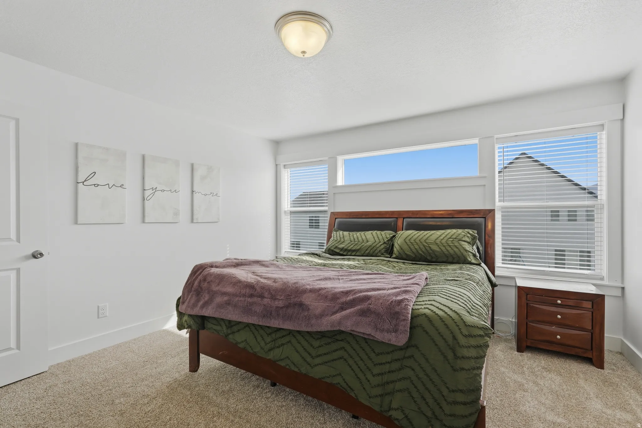 Bedroom featuring baseboards and light colored carpet