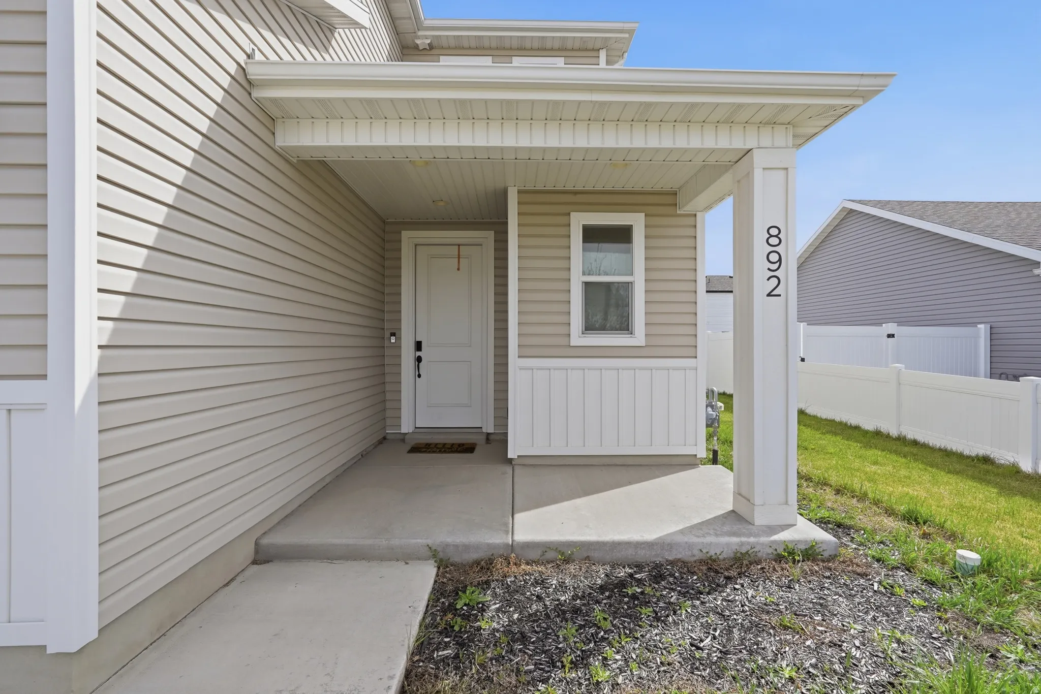 Entrance to property featuring covered porch and board and batten siding