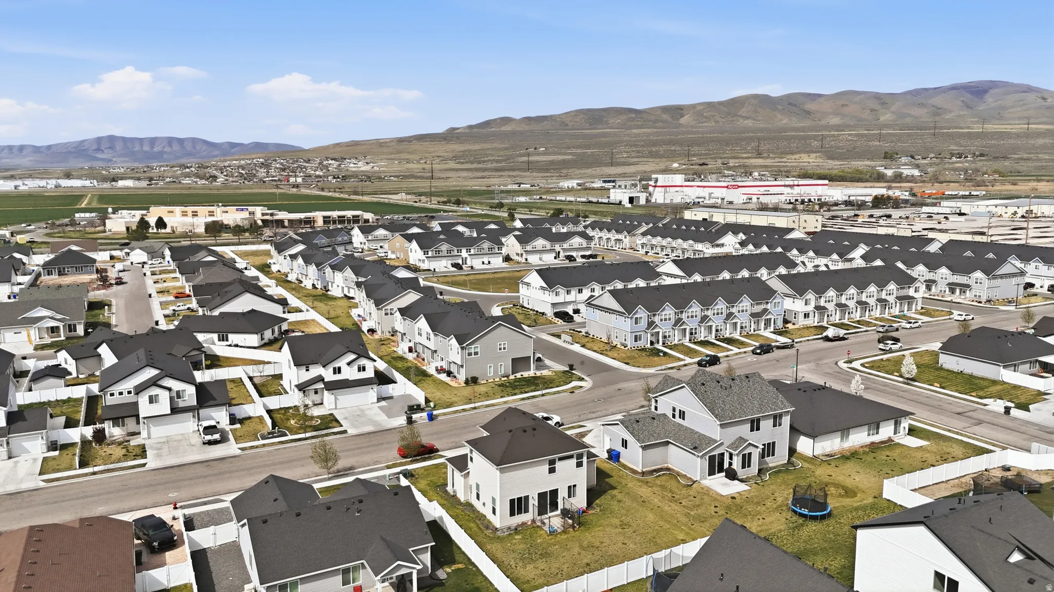 Aerial perspective of suburban area with a mountainous background