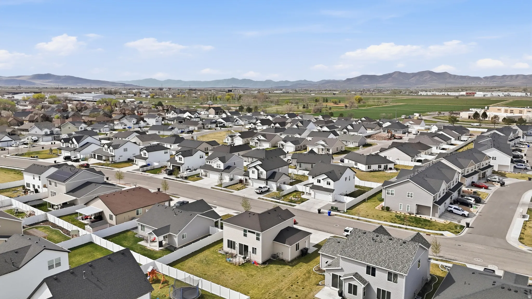 Aerial perspective of suburban area featuring a mountain backdrop