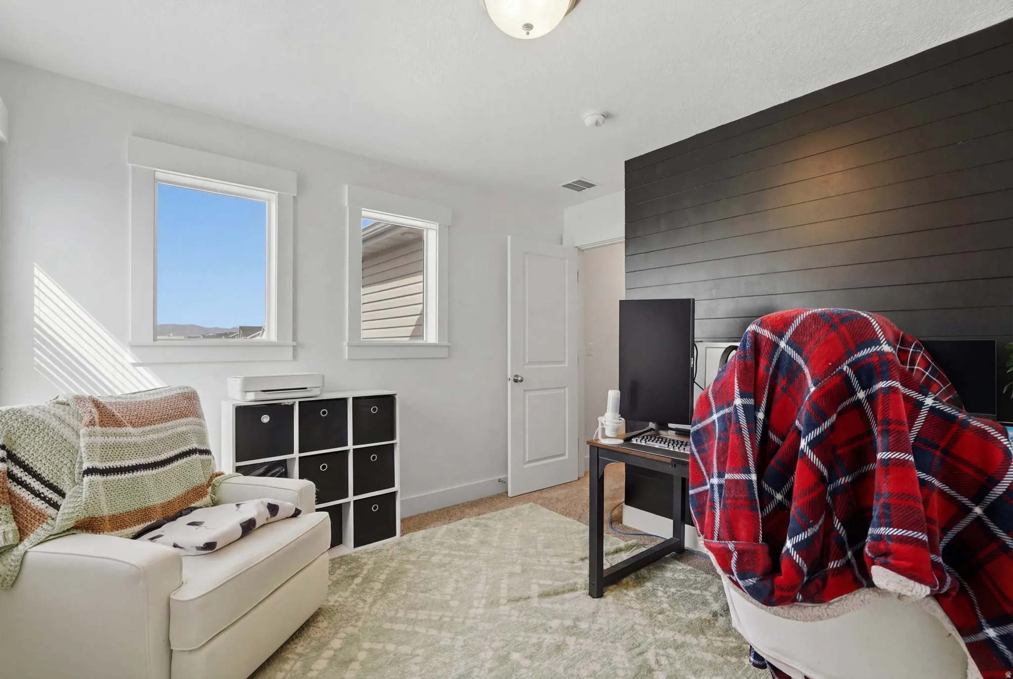 Bedroom featuring light colored carpet