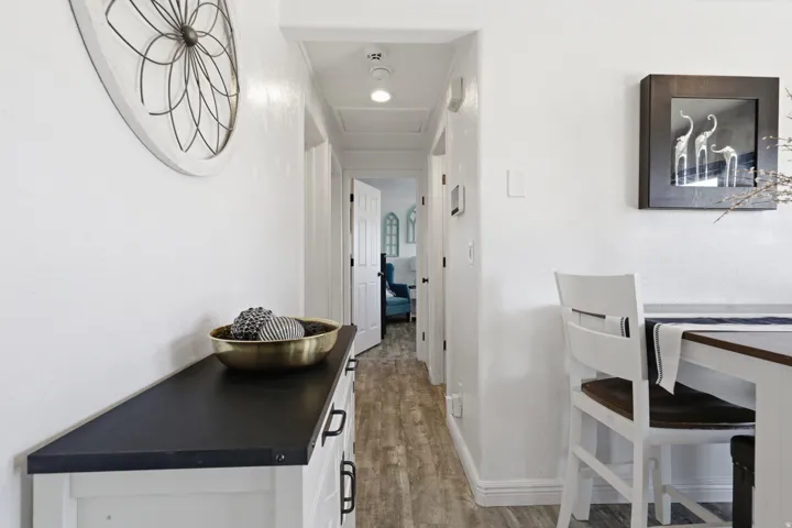 Hallway featuring light wood-type flooring and baseboards