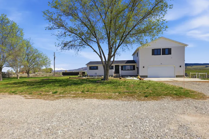 Traditional home with gravel driveway and a garage