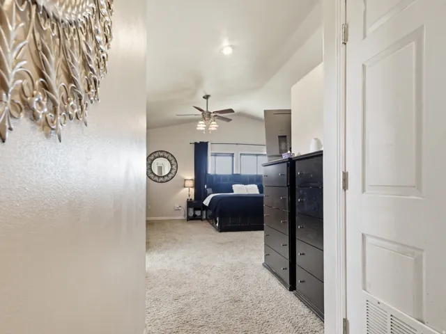 Bedroom featuring light carpet and a textured wall