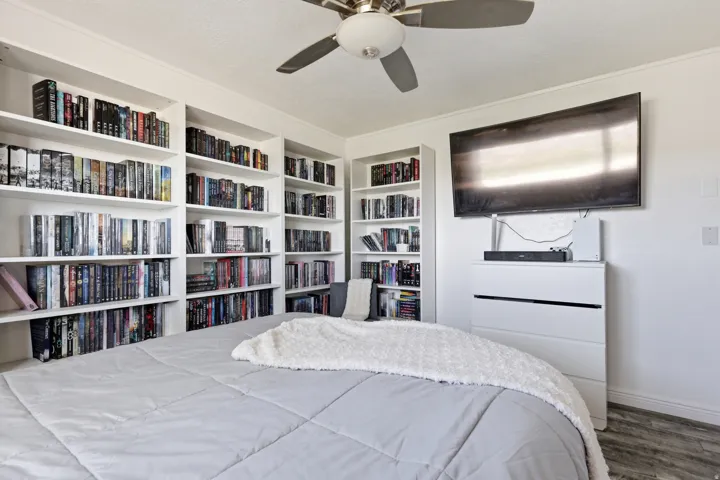 Bedroom with a ceiling fan and wood finished floors