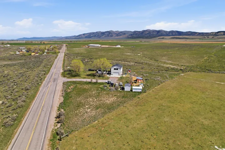 Aerial overview of property's location with rural landscape and mountains