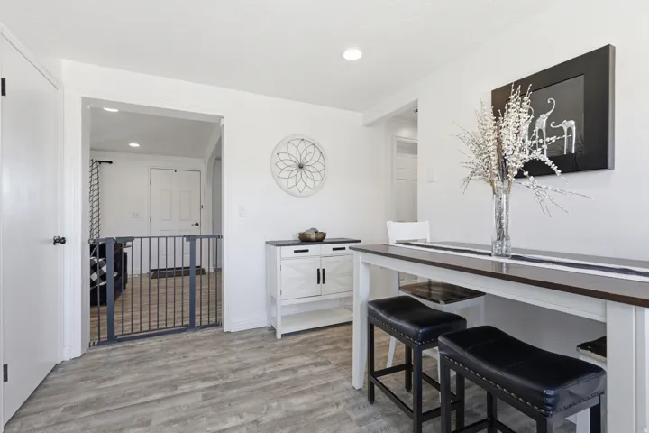 Dining space with light wood finished floors and recessed lighting